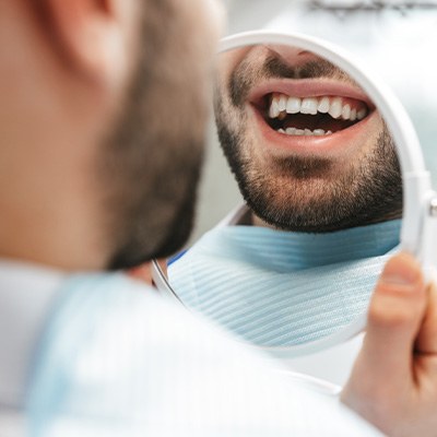Patient looking at smile in reflection