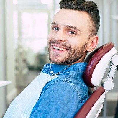 Patient smiling while sitting in treatment chair