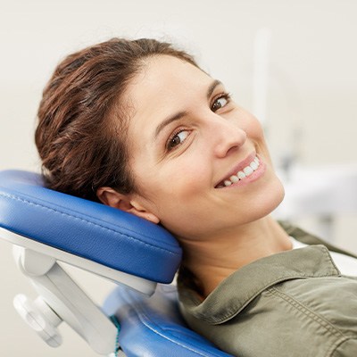 Patient smiling while sitting in treatment chair