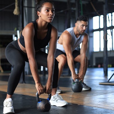 Two people working out in exercise class