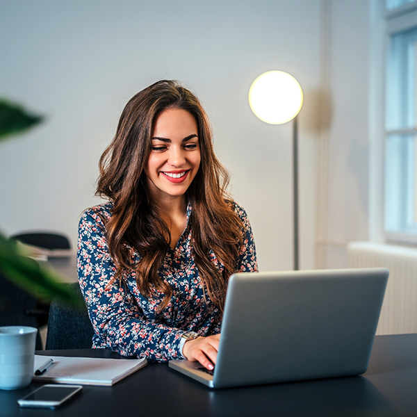 Woman sitting at a desk using her laptop