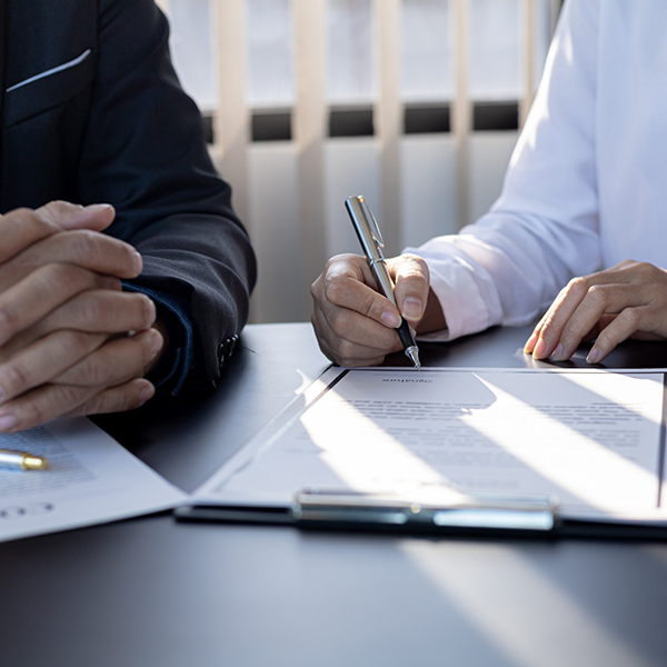 Person at a desk filling out paperwork