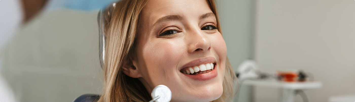 Woman smiling while at a dental checkup