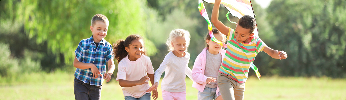 Group of kids running in a field after seeing their children's dentist in Little Elm