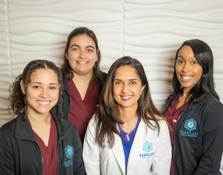 Doctor V smiling with three other Parklane Family Dentistry team members