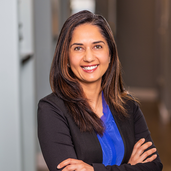 Little Elm dentist Doctor V smiling and standing with her arms crossed