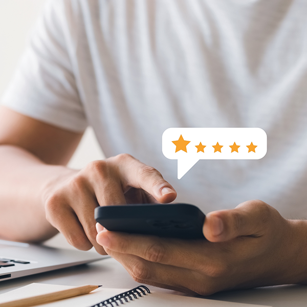 Person leaving a five star review on their phone